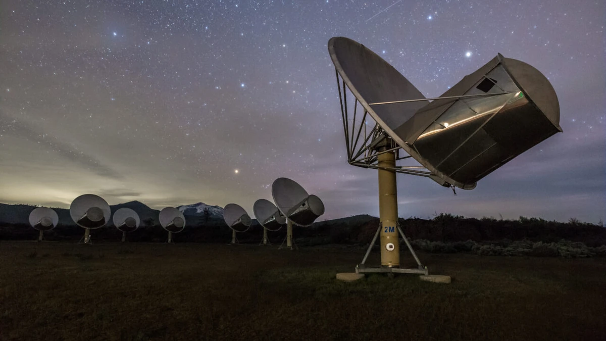 Allen Telescope Array dishes beneath a star-filled night sky