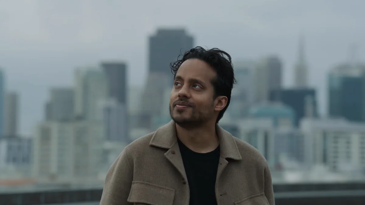 Speaker in the official GPT-Live-1 API launch video with a city skyline behind him