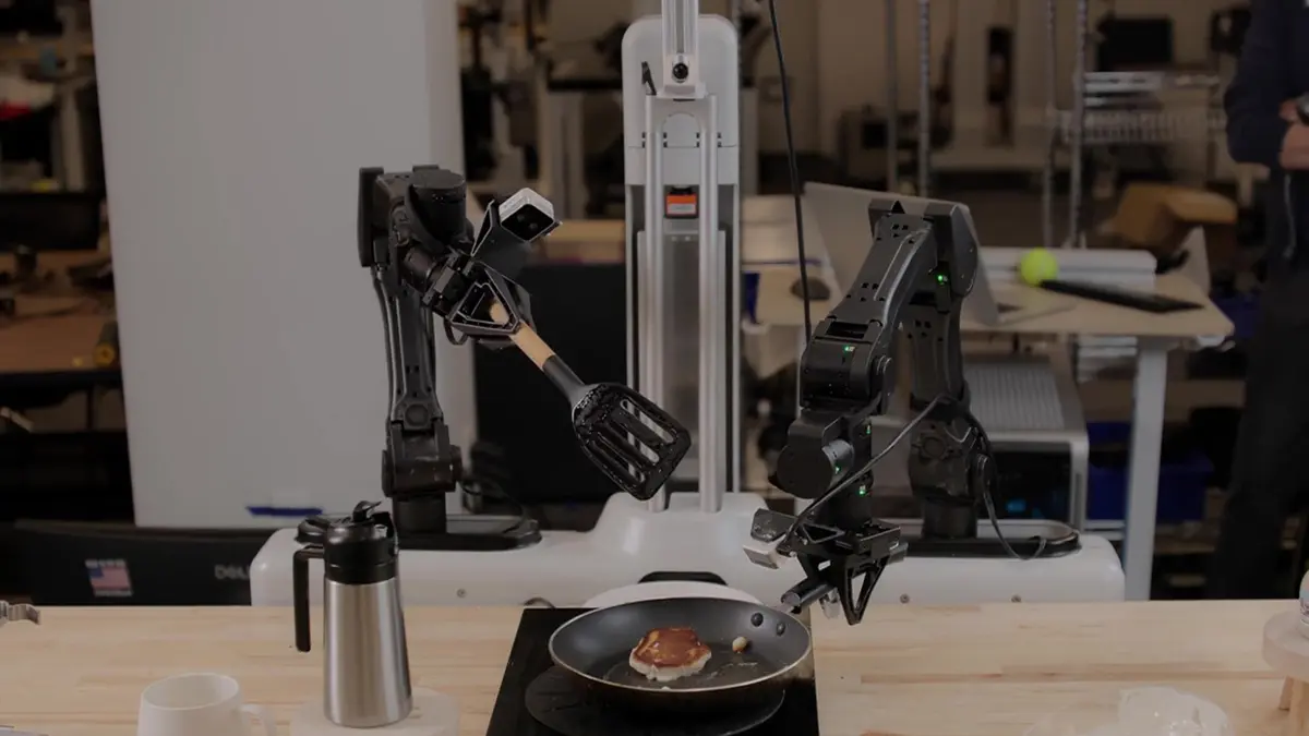 A dual-arm robot handling a spatula and pancake in Skild AI's S1 demonstration