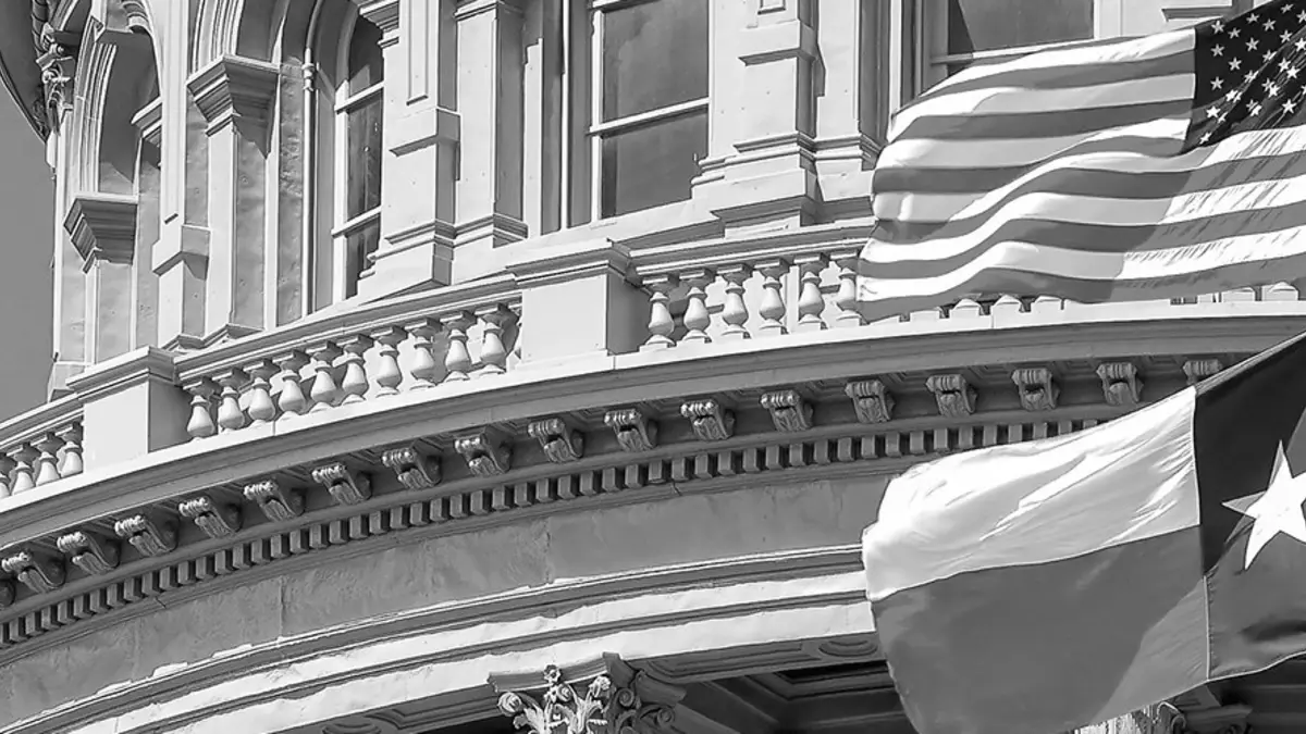 Texas Capitol and state flags in an official Governor of Texas news photograph